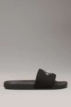 Calvin Klein Sandalias slides con logo grabado.